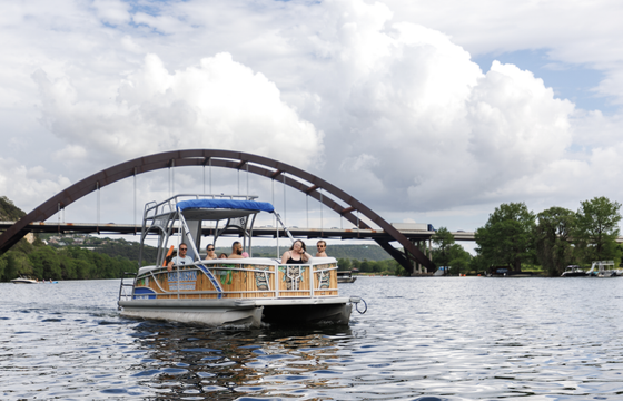 Double deck pontoon boat with slide on Lake Austin
