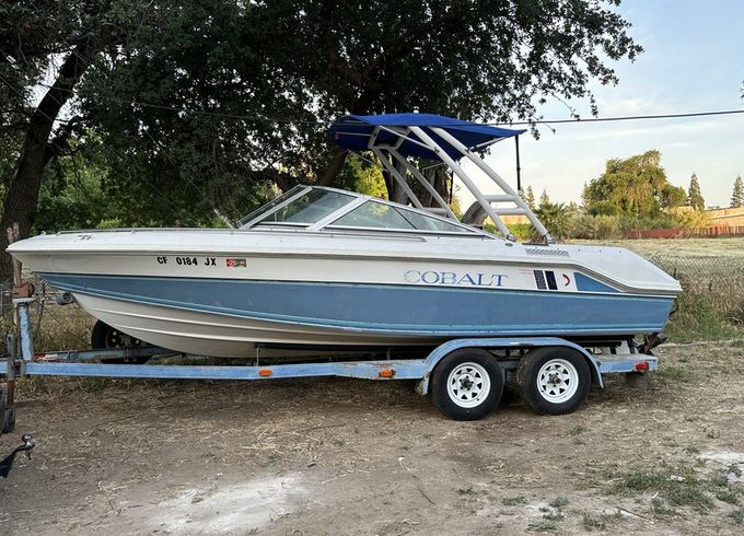 Experience the thrill of wake surfing on a classic 1989 Cobalt