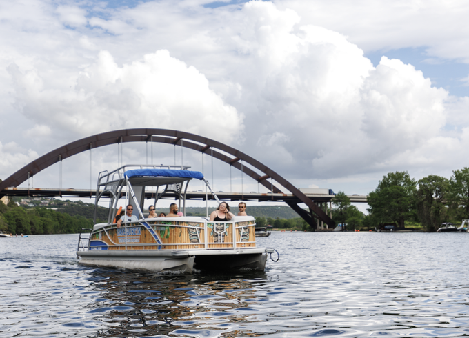 Double deck pontoon boat with slide on Lake Austin